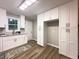Modern kitchen featuring ample white cabinets, stainless sink, and wood look floors at 2068 Verbena Nw St, Atlanta, GA 30314