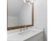Bathroom vanity featuring marble countertop, framed mirror, and modern fixtures under bright lighting at 215 Morris Ln, Woodstock, GA 30188