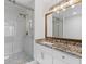Modern bathroom with glass shower, marble tiling, and granite vanity, perfect for relaxation at 215 Morris Ln, Woodstock, GA 30188