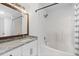 Modern bathroom featuring granite countertops, a soaking tub with shower, and updated fixtures at 215 Morris Ln, Woodstock, GA 30188