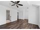 Spacious bedroom features hardwood floors, ceiling fan, and access to a modern bathroom at 215 Morris Ln, Woodstock, GA 30188