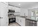 Cozy kitchen featuring stainless steel appliances, granite countertops, and bright natural light at 215 Morris Ln, Woodstock, GA 30188