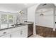 Bright kitchen with stainless steel appliances, granite countertops, and an open view to dining at 215 Morris Ln, Woodstock, GA 30188
