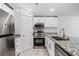 Well-lit kitchen with stainless steel appliances and granite countertops adds a touch of elegance at 215 Morris Ln, Woodstock, GA 30188