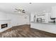 Open concept living space offering refinished hardwood floors, fireplace, and kitchen access at 215 Morris Ln, Woodstock, GA 30188