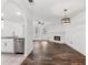 Open-concept living area with hardwood floors, fireplace, and modern stainless appliances at 215 Morris Ln, Woodstock, GA 30188