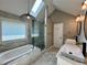 Bathroom featuring double sinks, a bathtub, a walk-in shower, and a skylight at 2610 Stokesley Way, Snellville, GA 30078