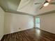 Bedroom with a tray ceiling, hardwood floors, and a ceiling fan at 2610 Stokesley Way, Snellville, GA 30078