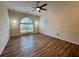 Dining area featuring hardwood floors, elegant lighting, and a large arched window at 2610 Stokesley Way, Snellville, GA 30078