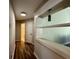 Hallway with decorative shelves, wood floors, and access to the bathroom at 2610 Stokesley Way, Snellville, GA 30078