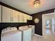 Well-lit laundry room with modern fixtures, cabinets, and washer/dryer at 2610 Stokesley Way, Snellville, GA 30078