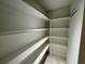 Walk-in pantry with built-in shelving provides ample storage space at 2610 Stokesley Way, Snellville, GA 30078