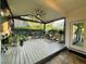 Charming screened-in porch with a ceiling fan, decorative railings and potted plants at 2610 Stokesley Way, Snellville, GA 30078