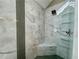Shower featuring a built-in bench, glass shelving, and marble tiling at 2610 Stokesley Way, Snellville, GA 30078