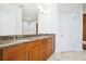 Double vanity bathroom with wooden cabinets, granite countertops, and a large mirror at 2828 Peachtree Nw Rd # 2002, Atlanta, GA 30305
