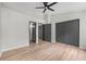 This is a bedroom with vinyl floors, a ceiling fan, a closet, and a door to the ensuite bathroom at 3072 Revere Ct, Atlanta, GA 30340