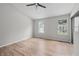 Bright bedroom with wood floors, ceiling fan, and natural light from two windows at 3072 Revere Ct, Atlanta, GA 30340