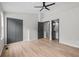 Large bedroom features wood floors, ceiling fan, closet, and access to a bathroom at 3072 Revere Ct, Atlanta, GA 30340