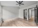 Bright bedroom featuring wood floors, a ceiling fan, and entry to the ensuite bathroom for a practical, modern feel at 3072 Revere Ct, Atlanta, GA 30340