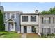 Charming townhome with a well-maintained front yard, neutral exterior, and black shutters on a sunny day at 3072 Revere Ct, Atlanta, GA 30340