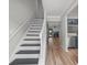 Inviting hallway features new flooring and stylish staircase leading to an open floorplan at 3072 Revere Ct, Atlanta, GA 30340