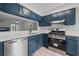 Modern kitchen featuring blue cabinets, stainless steel appliances, and light countertops at 3072 Revere Ct, Atlanta, GA 30340