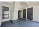 View of an enclosed patio with painted concrete floors, storage closets and entry doors at 3072 Revere Ct, Atlanta, GA 30340
