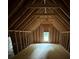 Spacious unfinished attic featuring exposed wooden beams and a window at 4110 Post Gate Ct, Cumming, GA 30040