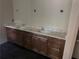 Bathroom features a double sink vanity with marble countertop and wood cabinets at 4110 Post Gate Ct, Cumming, GA 30040