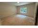 Bright bedroom with a large window providing ample natural light and a view of the outdoors at 4110 Post Gate Ct, Cumming, GA 30040