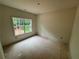 Unfinished bedroom with a large window overlooking the yard at 4110 Post Gate Ct, Cumming, GA 30040