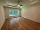 Large bedroom with hardwood floors, a ceiling fan, and a window offering natural light at 4110 Post Gate Ct, Cumming, GA 30040