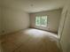 Unfinished bedroom with a large window overlooking the yard at 4110 Post Gate Ct, Cumming, GA 30040