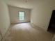 Unfinished bedroom with a large window overlooking the yard at 4110 Post Gate Ct, Cumming, GA 30040