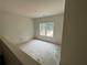 Unfinished bedroom with a large window providing natural light at 4110 Post Gate Ct, Cumming, GA 30040