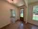 Inviting entryway with natural light, showcasing hardwood floors and a glimpse into the adjacent room at 4110 Post Gate Ct, Cumming, GA 30040