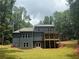 Exterior view of a two-story home featuring a deck and a large backyard at 4110 Post Gate Ct, Cumming, GA 30040