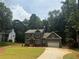 Two-story home with a well-manicured lawn and large driveway leading to an attached two-car garage at 4110 Post Gate Ct, Cumming, GA 30040