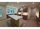 Bright kitchen featuring an island with marble countertop, wood cabinets, and a large window for natural light at 4110 Post Gate Ct, Cumming, GA 30040