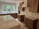 Kitchen featuring custom cabinets, marble countertops, and a view to the wooded lot at 4110 Post Gate Ct, Cumming, GA 30040