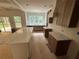 Bright kitchen with white marble countertops and unfinished cabinets and light-filled window at 4110 Post Gate Ct, Cumming, GA 30040