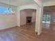 Open-concept living area with stone fireplace, hardwood floors, and ample natural light from surrounding windows at 4110 Post Gate Ct, Cumming, GA 30040