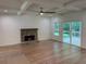 Spacious living room with a stone fireplace, coffered ceiling, and access to the outdoor deck at 4110 Post Gate Ct, Cumming, GA 30040