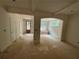 Living room featuring unfinished flooring, arched doorways, and multiple windows at 4110 Post Gate Ct, Cumming, GA 30040