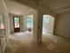 Living room with a view from the interior of windows looking to the yard and unfinished flooring at 4110 Post Gate Ct, Cumming, GA 30040