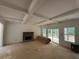 Living room featuring a stone fireplace, coffered ceilings, and sliding doors at 4110 Post Gate Ct, Cumming, GA 30040