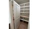 Well-organized pantry featuring custom shelving for efficient storage and easy access to kitchen essentials at 4110 Post Gate Ct, Cumming, GA 30040