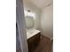 Compact powder room with a marble countertop, vanity, modern light fixture, and wood floor at 4110 Post Gate Ct, Cumming, GA 30040