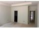 Spacious room with high ceilings, neutral walls, and doorway leading to a bathroom at 4110 Post Gate Ct, Cumming, GA 30040