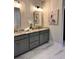 Stylish bathroom featuring double vanity, granite counters, bronze fixtures and lovely heron artwork at 101 Red Oak Ln, Carrollton, GA 30116